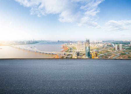 empty floor with backdrop on modern cityscape at sunrise timeの写真素材