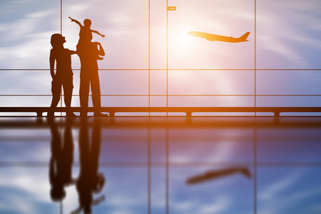 Silhouette of young family and airplaneの写真素材
