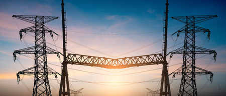 Impression network at transformer station in sunrise, high voltage up to yellow sky take with yellow tone, horizontal frameの写真素材