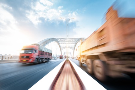 truck speeding through a bridge at sunset,motion blur.の写真素材