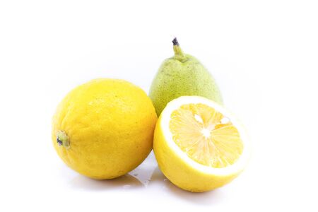 Two yellow pears and quarter split isolated on white background as package design elementの写真素材