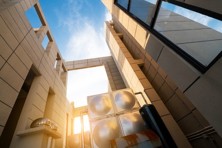 Bright outlook for business. Modern office block with sunny beautiful sky.