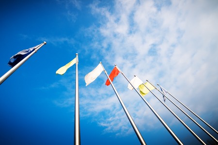 Empty white clear flag waving against clean blue sky