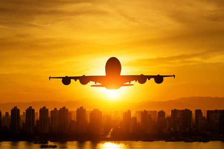 Passenger plane is landing during a wonderful sunrise.の写真素材