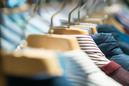Selective focus winter coats hanged on a clothes rack.の写真素材