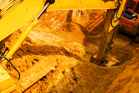 Large excavator on a fieldの写真素材