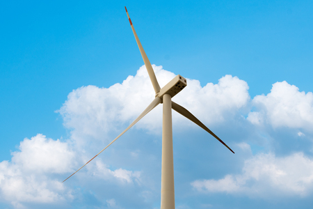 Green renewable energy concept - wind generator turbines in skyの写真素材