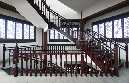 Stairs and glossy wooden floor of beautiful attractive luxury house with white walls having round...