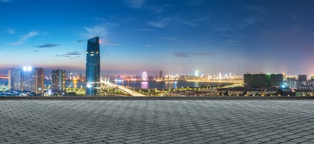 modern buildings near shanghai at night from empty floorの写真素材