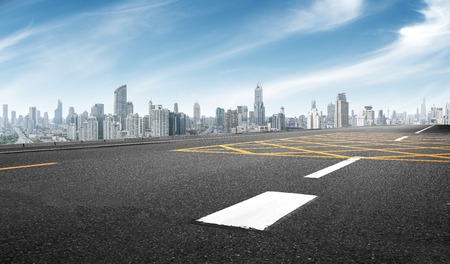 empty asphalt road with cityscape of shanghai in blue skyの写真素材