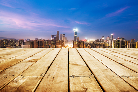 empty wooden floor with cityscape of hangzhou at twilightの写真素材