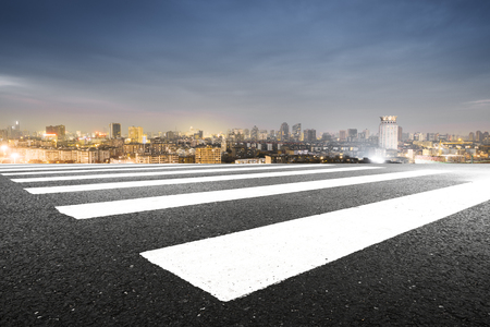 blur emtpy asphalt road and cityscape of shanghai in blue cloud sky at twilightのeditorial素材