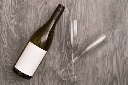 Red wine glasses and bottle on stone background. Top view with copy spaceの写真素材