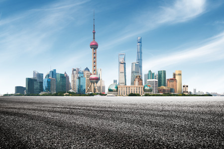 clean asphalt road with city skyline background, shanghai, china.の写真素材