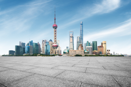 clean asphalt road with city skyline background, shanghai, china.の写真素材