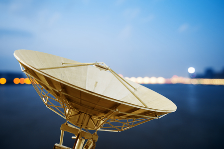 Large satellite antenna under twilight sky backgroundの写真素材
