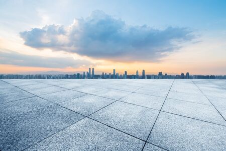 empty concrete floor and modern buildings in midtown of singapore in blue cloud skyの写真素材