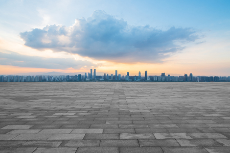empty concrete floor and modern buildings in midtown of singapore in blue cloud skyの写真素材