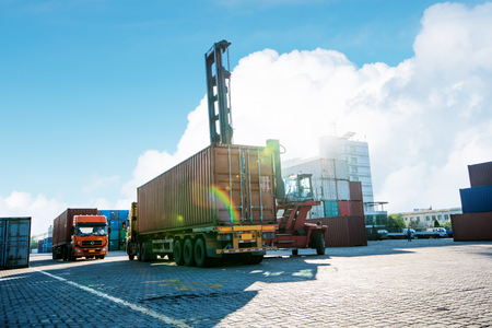 Crane lifting up container in yardのeditorial素材