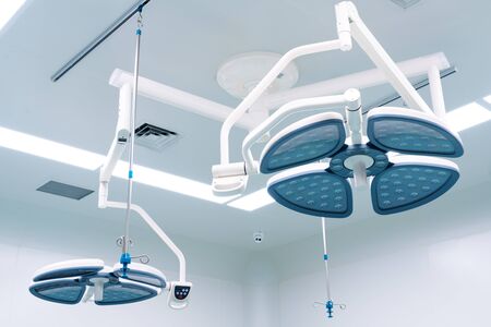 Working surgeon on the background of surgical lamp.の写真素材