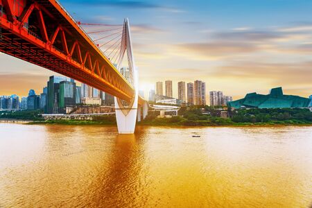 cityscape and skyline of downtown near water of chongqing at sunsetの写真素材