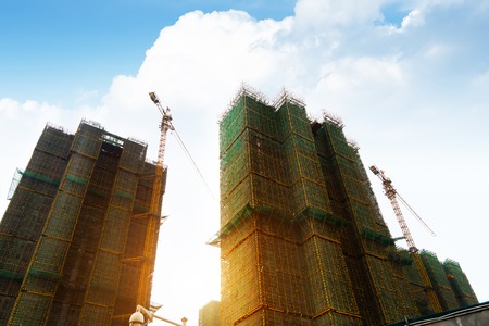 Construction site with cranes on sky background