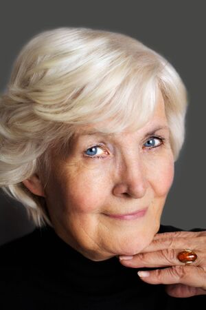 Senior lady portrait on dark grey background