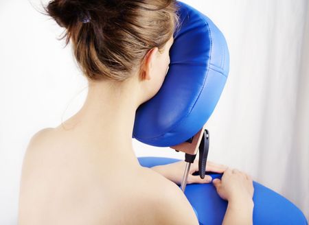 Young woman waiting for her treatment on massage seatの写真素材