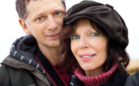 Mature couple porträt,outdoors with jacket and capの写真素材