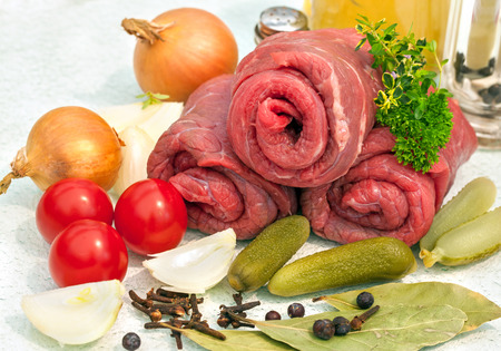 Three raw beef olives with ingredientsの写真素材