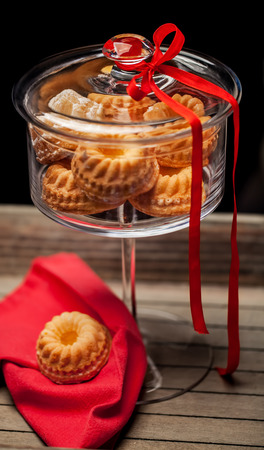 Small cake in a glass with red ribbonの写真素材