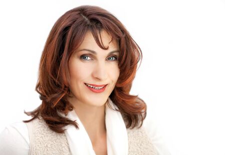 Mature lady looking relaxed at camera on white backgroundの写真素材