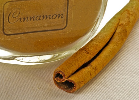 cinamon ground in jar with cinamon sickの写真素材