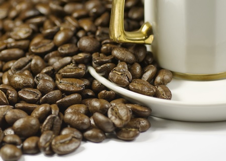 coffe beans by gold handle cup with handleの写真素材