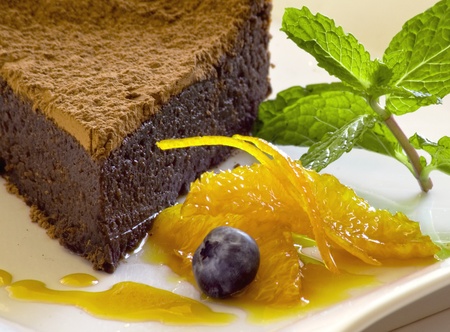 chocolate cake with orange garnish and mintの写真素材