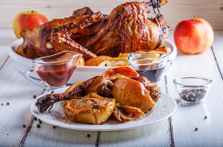 Duck baked with apples served with pomegranate and cranberry sauceの写真素材