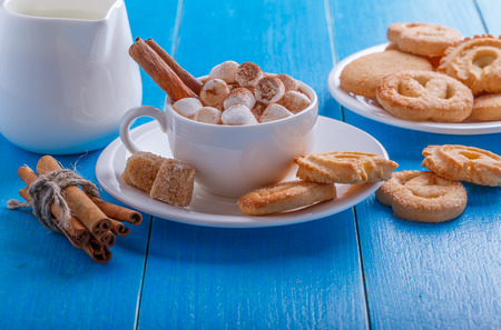 hot chocolate with marshmallow and cinnamon on a blue backgroundの写真素材