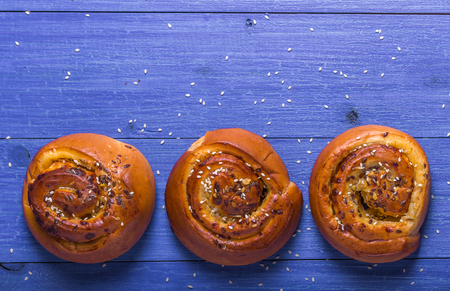 fresh rolls with sesame seeds and sunflower seeds on a blue backgroundの写真素材