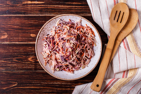 Homemade coleslaw in bowl on dark wooden background.の写真素材