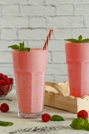 Raspberry milkshake with mint and drinking straws.の写真素材