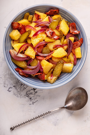 Homemade potato salad with bacon and pickles, top view.の写真素材