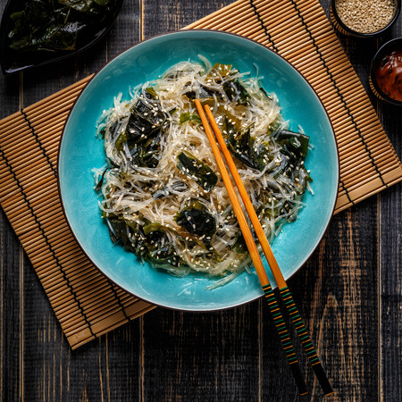 Funchoza salad with wakame on dark background, top view.の写真素材
