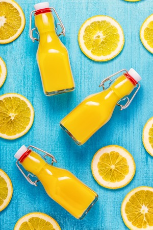 Orange juice on a blue background, top view.の写真素材