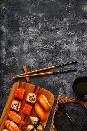 Sushi Set: sushi and sushi rolls on wooden plate, top view.の写真素材