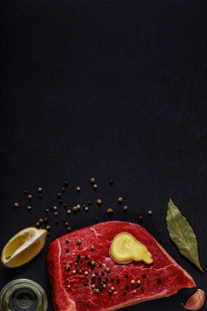 Raw steak with spices and ingredients for cooking. Top view, copy space.の写真素材