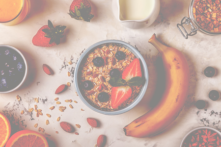 Healthy breakfast - a bowl of oatmeal, berries and fruit, orange juice, milk, top view.の写真素材