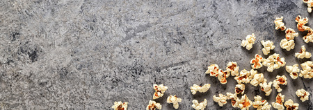 Popcorn on a concrete background, top view, banner, space for text.の写真素材