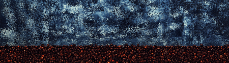 Coffee beans on a dark background of a concrete, place for the text, top view,