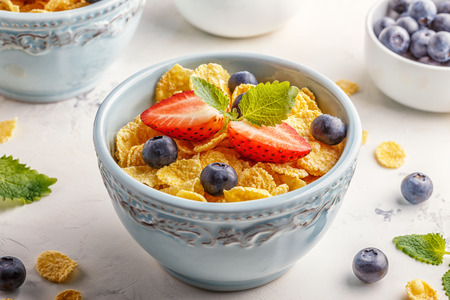 Healthy breakfast - corn flakes with fruits and berries, selective focus.