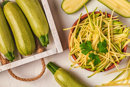 Raw zucchini pasta on white background, copy space, top view.の写真素材